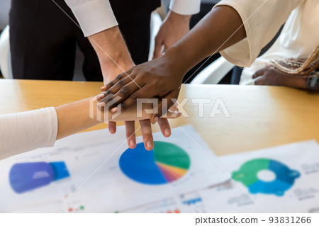 Diverse colleagues gather putting their hands together. Diverse colleagues gather putting their hands together. 93831266