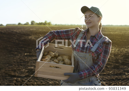 Happy smiling caucasian female potato farmer or gardener. Agriculture - food production, harvest concept 93831349