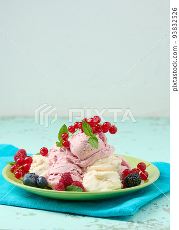 Vanilla ice cream balls with red raspberries in a round plate. Vanilla ice cream balls with red raspberries in a round plate. 93832526