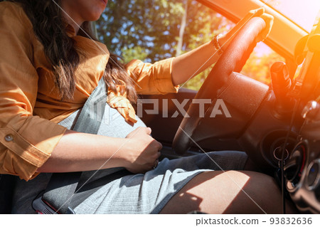 Pregnant driving car. Young smiling pregnancy woman driving car. Safety pregnant young mom driving concept. Pregnant driving car. Young smiling pregnancy woman driving car. Safety pregnant young mom driving concept. 93832636