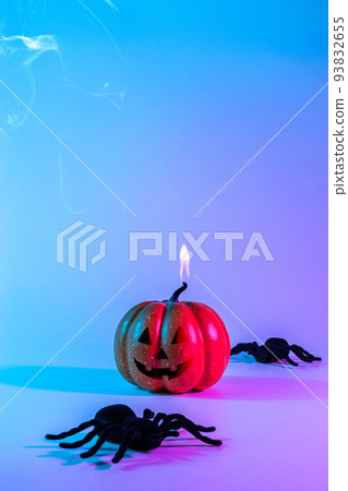 Halloween background. Scary spooky pumpkin, black night spider on night neon helloween backdrop. Minimalistic background for autumn holidays. Space for text. Halloween background. Scary spooky pumpkin, black night spider on night neon helloween backdrop. Minimalistic background for autumn holidays. Space for text. 93832655