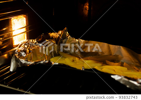 Potatoes on a dish in the oven Potatoes on a dish in the oven 93832743