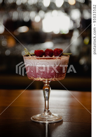 pink cocktail with a layer of white foam 93833582