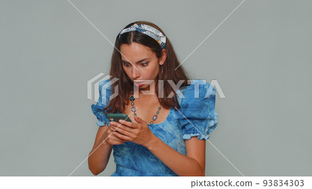 Sad young woman use smartphone, loses becoming surprised sudden lottery results, bad fortune, loss 93834303