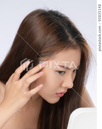Closeup portrait of gorgeous asian woman looking at mirror worry about pimple. 93835148