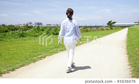 Back view of a middle-aged woman walking Back view of a middle-aged woman walking 93836076
