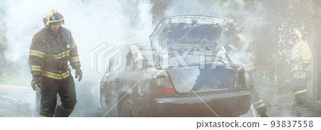 The fire brigade extinguishes a burning car. Arson of a car in the city. The fire brigade extinguishes a burning car. Arson of a car in the city. 93837558
