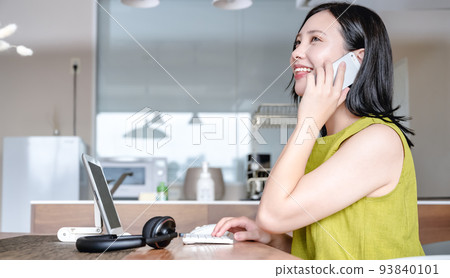 Young woman working from home Contacting by smartphone Young woman working from home Contacting by smartphone 93840101