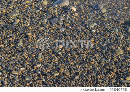 Stones and bubbles when the waves recede 93840768