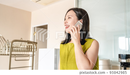 A young woman calling with a smartphone 93842985
