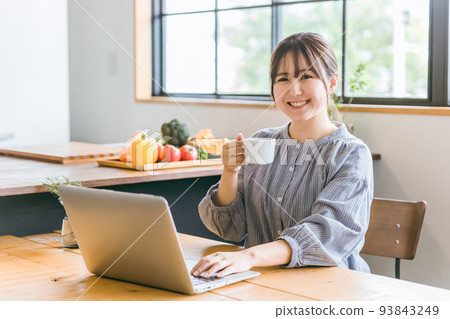 Japanese woman teleworking at home (coffee, break) 93843249