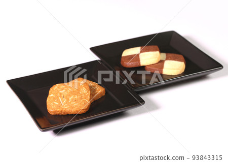 almond and mosaic cookies on a plate 93843315