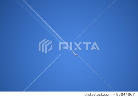 Airplane and blue sky with contrails Airplane and blue sky with contrails 93844867