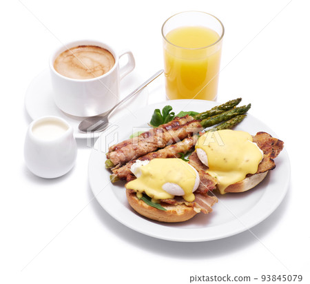Healthy food - Asparagus wrapped with bacon and benedict poached eggs on a plate isolated on white background Healthy food - Asparagus wrapped with bacon and benedict poached eggs on a plate isolated on white background 93845079