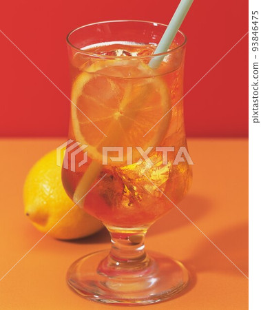 Image of lemon slice falling into juice 93846475