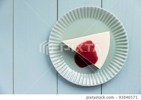 No-bake cheesecake with blueberry sauce on a wooden table 93846571