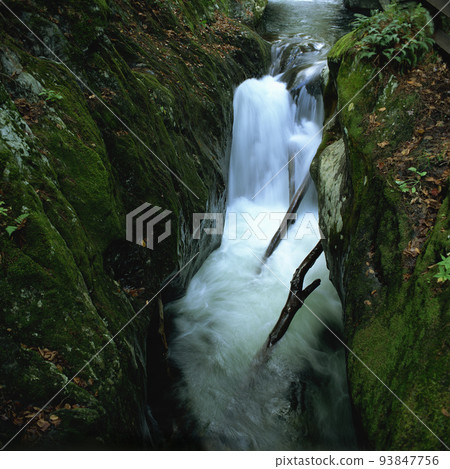 Cascade falls over mossy rocks Cascade falls over mossy rocks 93847756