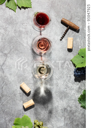 Wine composition with beautiful sunlight and shadows on grey background. Top view, flat lay Wine composition with beautiful sunlight and shadows on grey background. Top view, flat lay 93847925