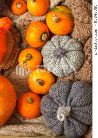 Cozy autumn still life with pumpkins, knitted woolen plaid and decor. Autumn home decor. Warming fall mood. Autumn holiday, weekend. Thanksgiving. Halloween. Banner, flyer, greeting card 93848080