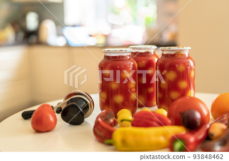Home canning of vegetables. Canning yellow tomatoes in tomato juice 93848462