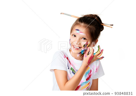 child girl in colorful paint with paintbrush in hair child girl in colorful paint with paintbrush in hair 93848831
