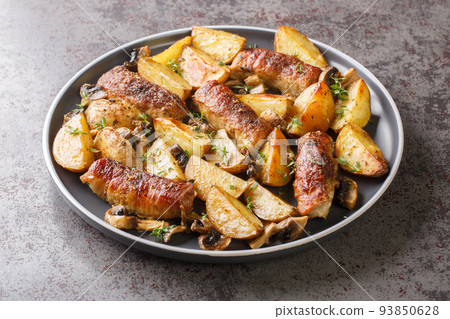 Comfort food meat rolls with mushrooms and potatoes close-up in a plate. horizontal 93850628