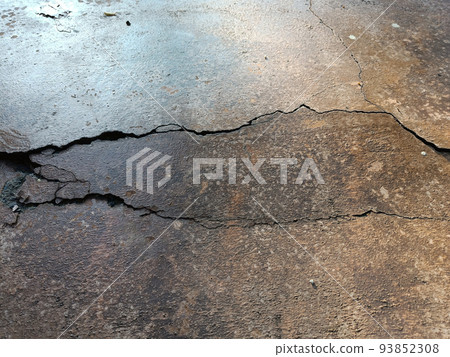 Cracked concrete ground broken at floor home or street road subside from earthquake_2 93852308