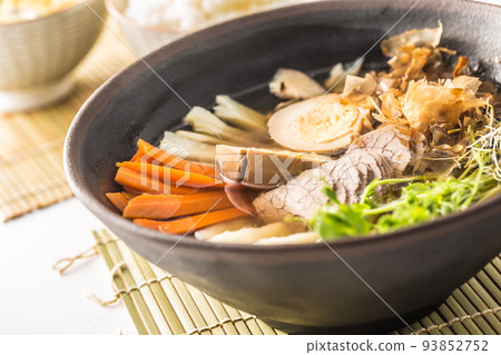 Japanese soup ramen with beef meat, egg and carrot on table in asian restaurant. 93852752
