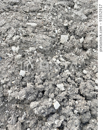 Vertical image material of large and small gray crushed stones and soil laid as embankment 93852917