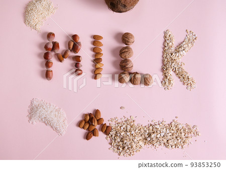 Flat lay. Lettering Milk using various nuts, cereals and seeds on pink background. Non dairy organic raw vegan healthy drink, made from rice, sesame, coconut, oats, almonds, walnuts and hazelnuts Flat lay. Lettering Milk using various nuts, cereals and seeds on pink background. Non dairy organic raw vegan healthy drink, made from rice, sesame, coconut, oats, almonds, walnuts and hazelnuts 93853250