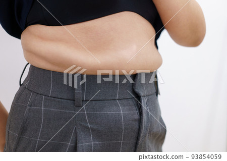 Women body fat belly. Obese woman hand holding excessive belly fat. diet lifestyle concept to reduce belly and shape up healthy stomach muscle. 93854059