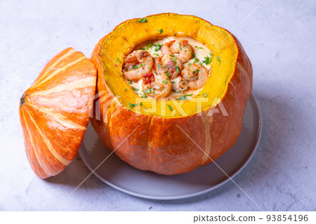 Pumpkin stuffed with shrimps and cheese, whole baked. Traditional Brazilian dish. Close-up. 93854196