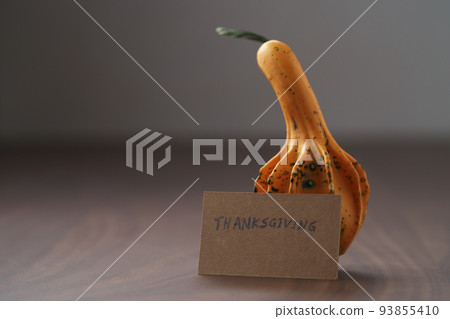 Decorative small pumpkin on wood table with thanksgiving greeting card Decorative small pumpkin on wood table with thanksgiving greeting card 93855410