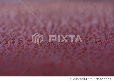 Closeup wet red car paint surface with hydrophobic ceramic coating 93855563