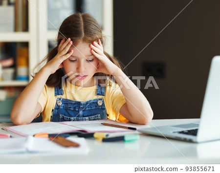 Confused child thinking over difficult task and doing homework at home 93855671