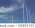 Flag pole not raised looking up from the blue sky and the back of the net 93855735