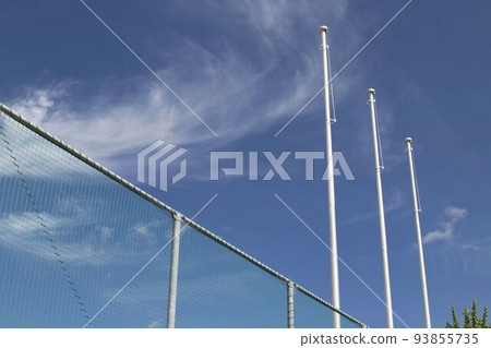 Flag pole not raised looking up from the blue sky and the back of the net Flag pole not raised looking up from the blue sky and the back of the net 93855735