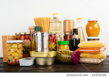 Emergency survival food set on dark wooden kitchen table Emergency survival food set on dark wooden kitchen table 93856486