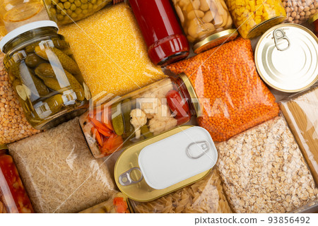 Emergency survival groceries on kitchen table closeup flat lay Emergency survival groceries on kitchen table closeup flat lay 93856492