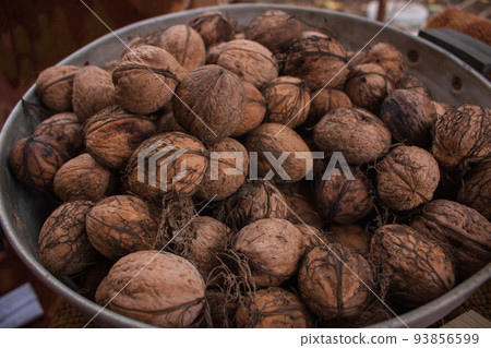 Group of walnuts. Close up of walnuts. Autumn harvest. Dried nuts. Rural nature background. Raw healthy food. Nuts shell. Tasty organic snack. Vegetarian food. Group of walnuts. Close up of walnuts. Autumn harvest. Dried nuts. Rural nature background. Raw healthy food. Nuts shell. Tasty organic snack. Vegetarian food. 93856599