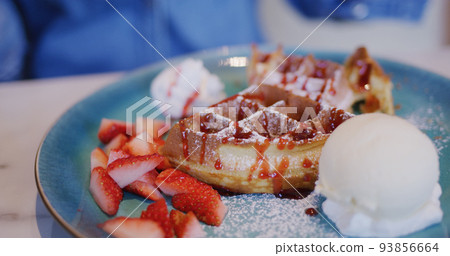 Waffle with ice cream and strawberry in restaurant 93856664