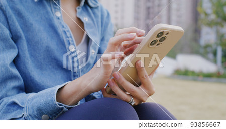 Woman use of smart phone at outdoor 93856667