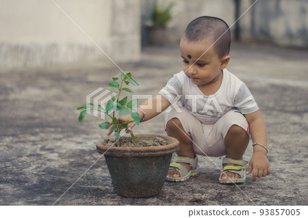 Cute Little baby boy with Flower tub sitting at outdoor Cute Little baby boy with Flower tub sitting at outdoor 93857005
