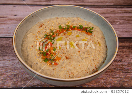 Traditional arabian eggplant dip baba ganoush with herbs and smoked paprika on a wooden background Traditional arabian eggplant dip baba ganoush with herbs and smoked paprika on a wooden background 93857012