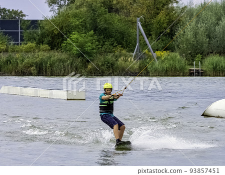Teenager wakeboarding on a lake - Brwinow, Poland 93857451