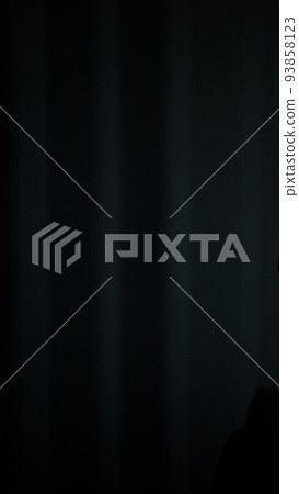 Background image of curtains in a dimly lit room. 93858123