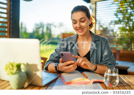 woman is working sitting on the patio woman is working sitting on the patio 93858285