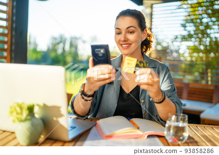 Woman is doing online purchases Woman is doing online purchases 93858286