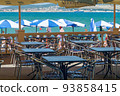 Umbrellas and cafe tables line the Gelendzhik promenade facing the bay. 93858415