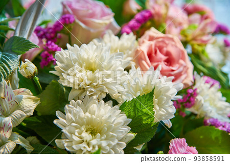 Bouquet of flowers of roses, chrysanthemums close-up. Natural background. 93858591